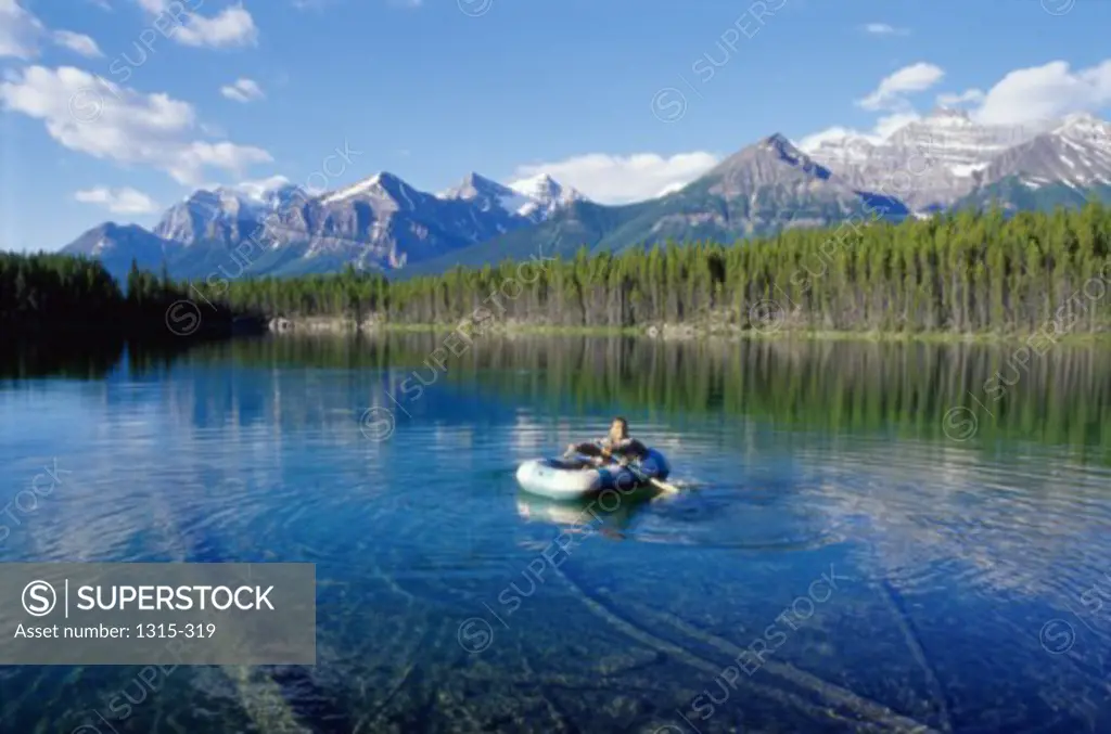 Man rafting in a lake, Herbert Lake, Banff National Park, Alberta, Canada