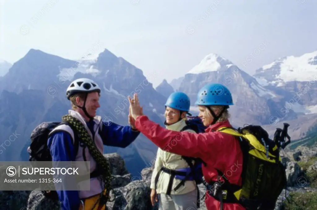 Two young women and a young man on a mountain, Lake Louise, Alberta, Canada