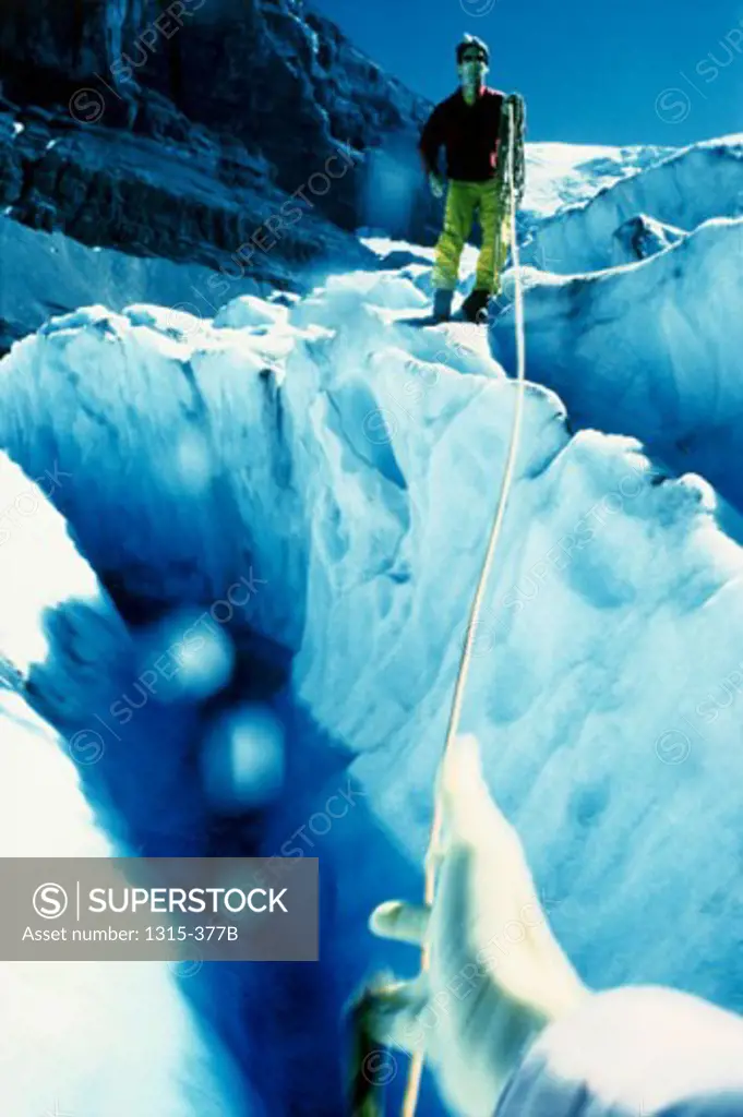 Mountaineer standing at the edge of a crevice, Columbia Icefield, Jasper National Park, Alberta, Canada