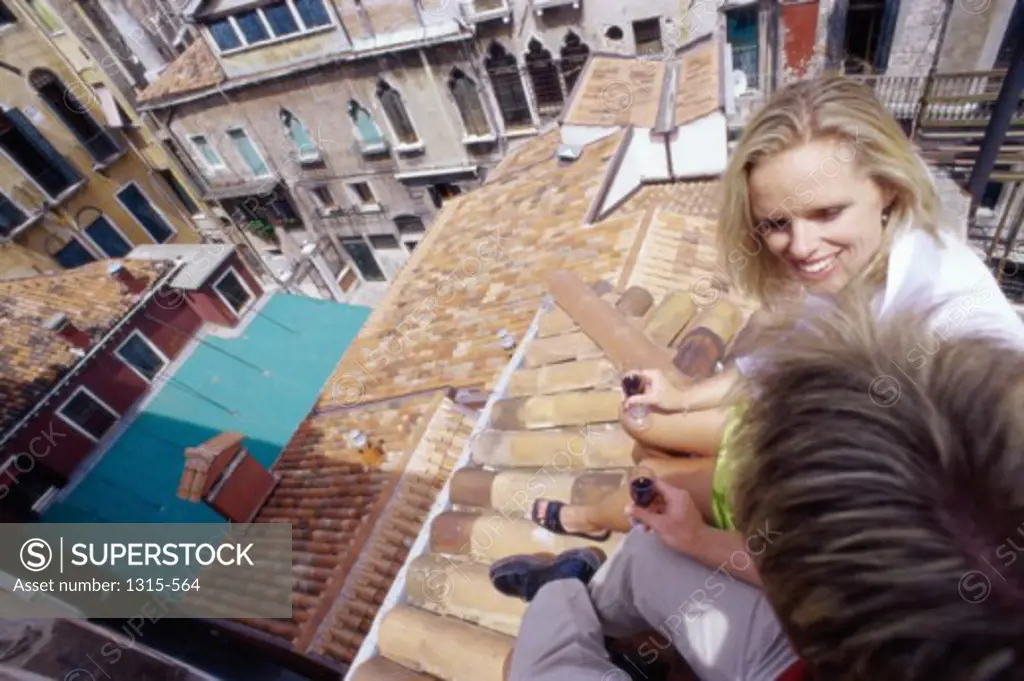 High angle view of a mid adult couple holding wineglasses, Venice, Italy
