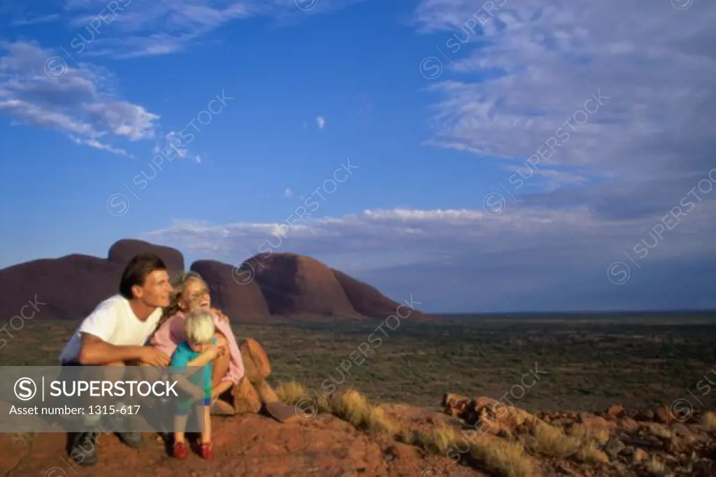Parents with their son on a landscape, Uluru-Kata Tjuta National Park, Australia