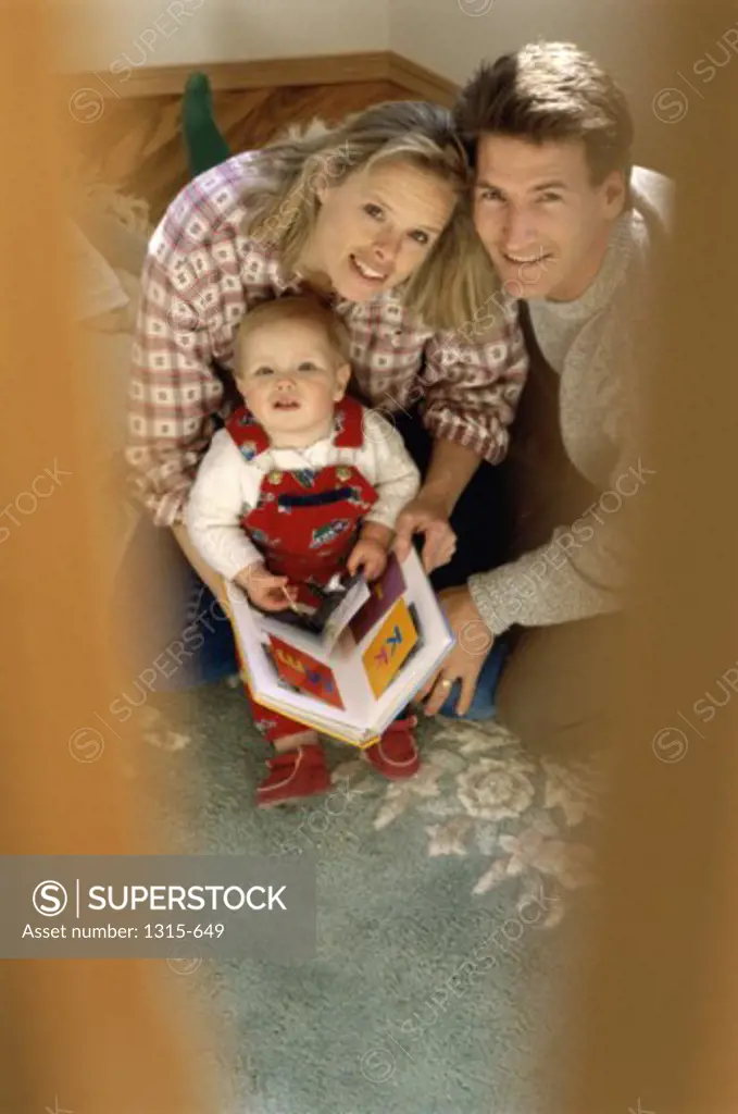 Portrait of parents smiling with their son