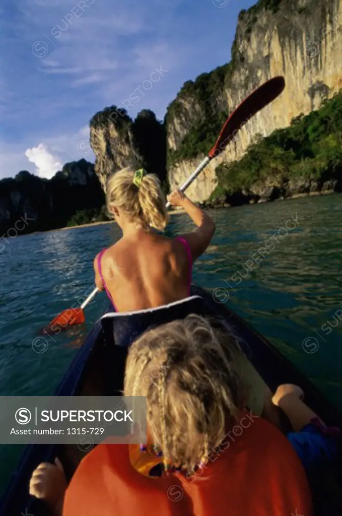 Rear view of a mother and daughter boating, Krabi, Thailand
