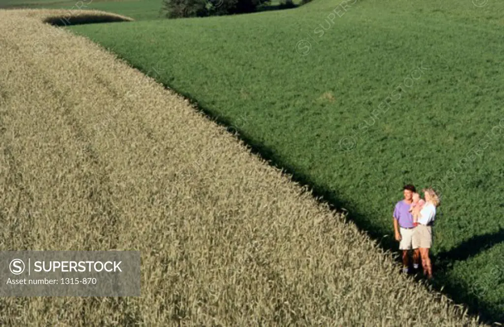 High angle view of parents with their son standing in a field