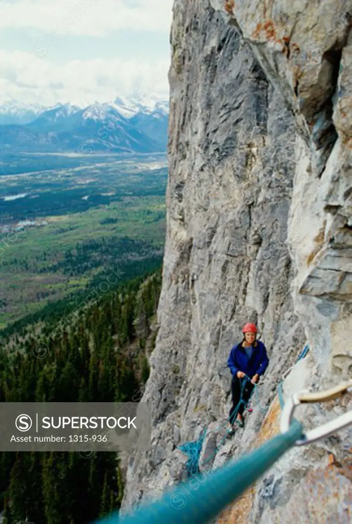 High angle view of a woman climbing a cliff, Canadian Rockies, Canada