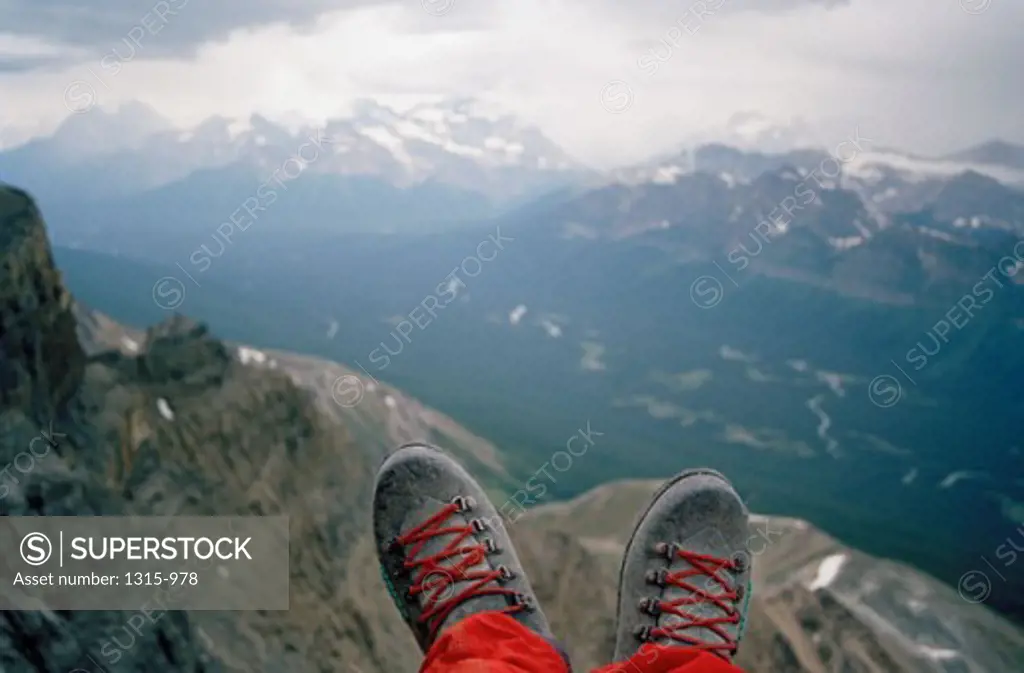 Close-up of a person's feet with mountains in the background, Banff National Park, Alberta, Canada