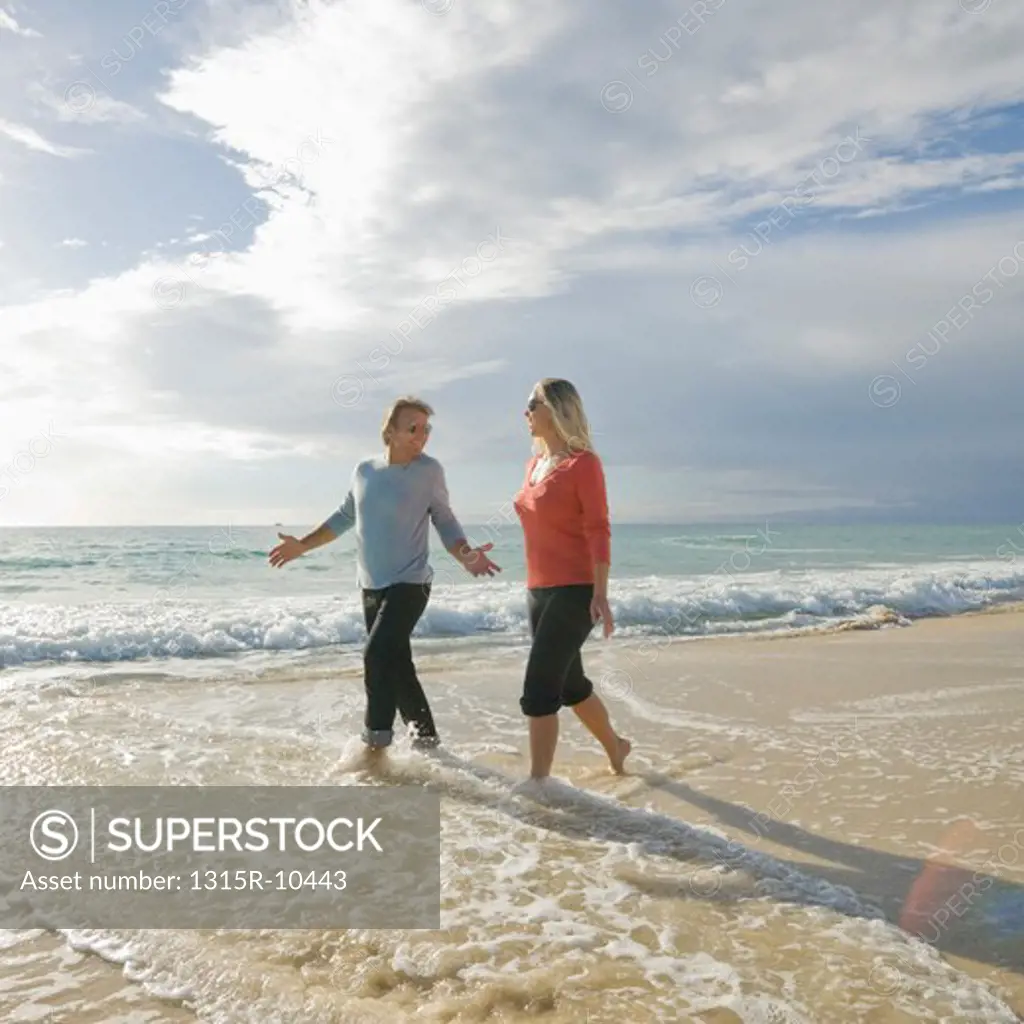 Tunisia, Couple walking along beach