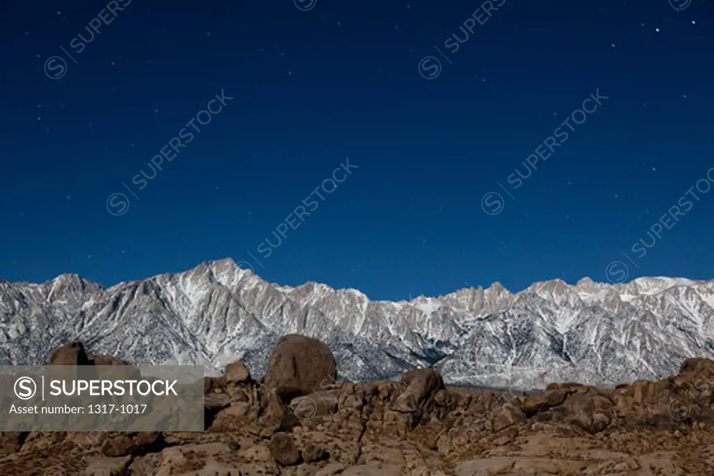 Low angle view of mountains in moonlight at night, Alabama Hills, Lone Pine Peak, Mt Whitney, Californian Sierra Nevada, California, USA