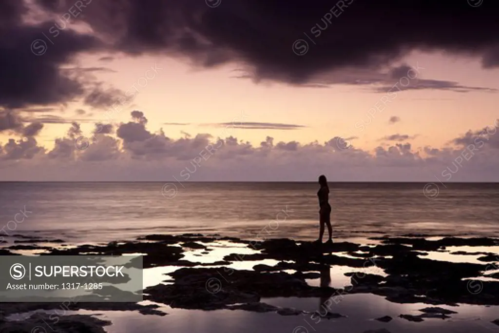 Silhouette of a woman standing on the coast, Spanish Key, Florida, USA