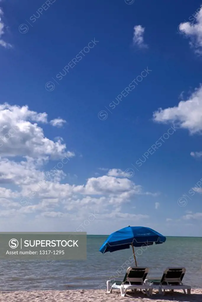 Lounge chairs and beach umbrella on the beach, Key West, Florida, USA