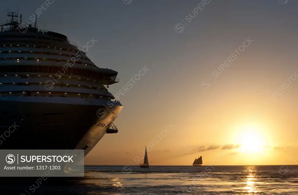 USA, Florida, Key West, Sailboats and cruise ship at sunset