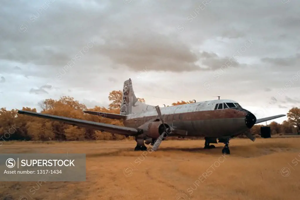 Abandoned rusting passenger plane in a field, USA