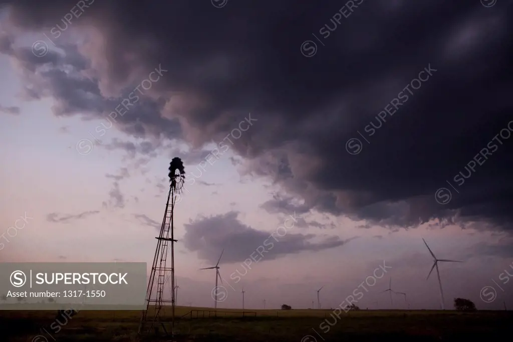 USA, Texas, Wind turbines under storm clouds