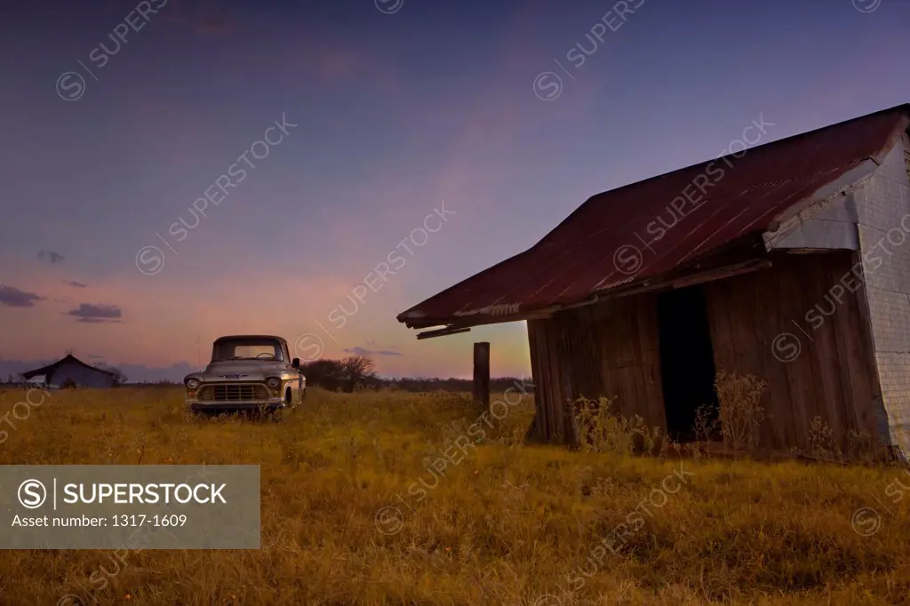 Old farm truck and abandoned house in a farm, Texas, USA