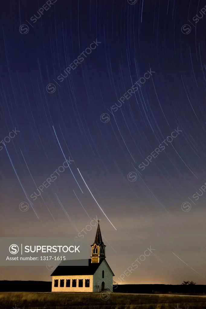 Star trails in the sky over St. Olaf Lutheran Rock Church, Texas Hill Country, Texas, USA