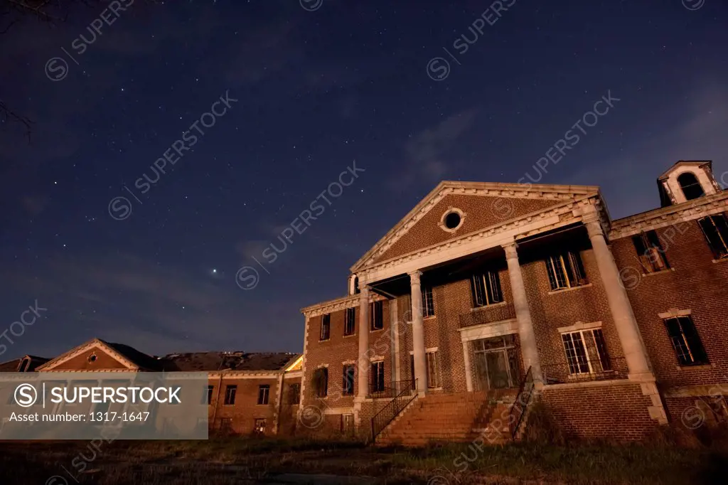 USA, Texas, Abandoned old orphanage building exterior at night