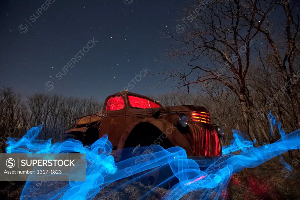 USA, West Texas, Old abandoned old farm truck at night