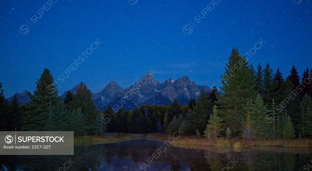 Reflection of mountain and trees in a river viewed from Schwabachers Landing, Snake River, Grand Teton National Park, Wyoming, USA