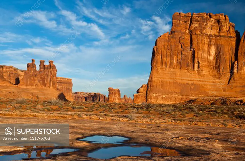 Reflection of rocks in water, Three Gossips, Courthouse Towers, Arches National Park, Utah, USA