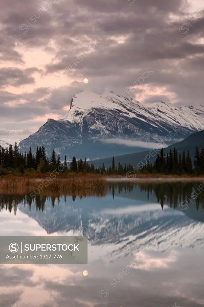 Reflection of mountains and clouds in a lake, Mt Rundle, Banff National Park, Alberta, Canada