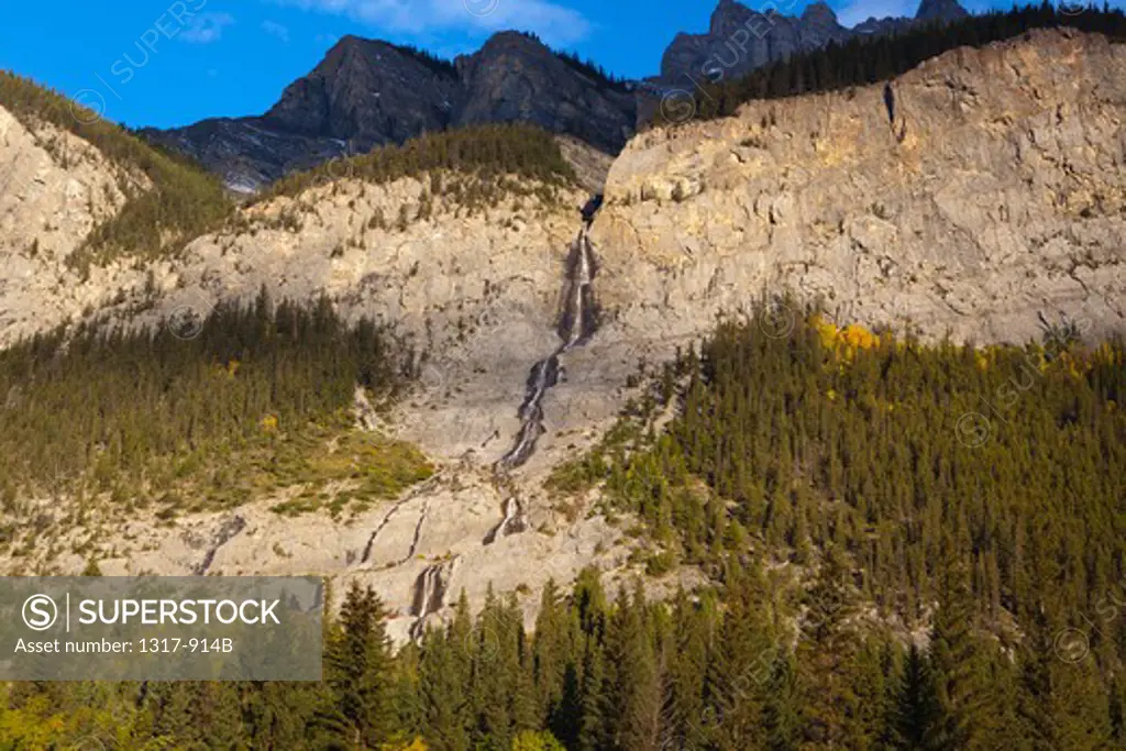 Waterfall cascading down mountain cliff, Cascade Falls, Bow Valley Parkway, Banff National Park, Alberta, Canada