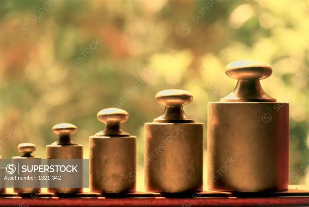 Close-up of metal weights arranged in a row