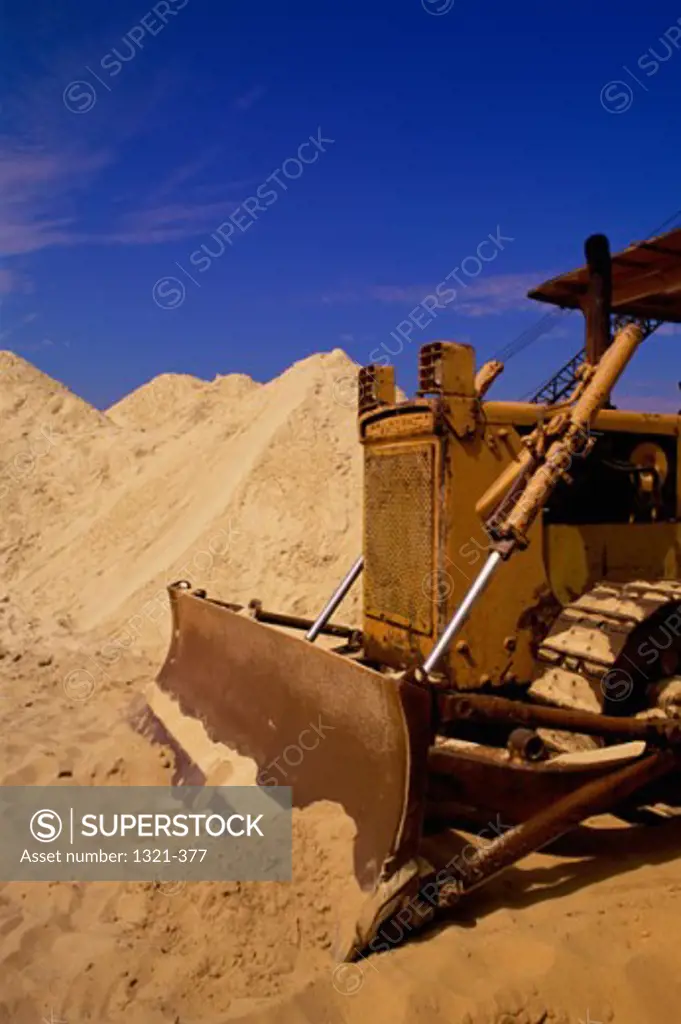 A Bulldozer pushing sand