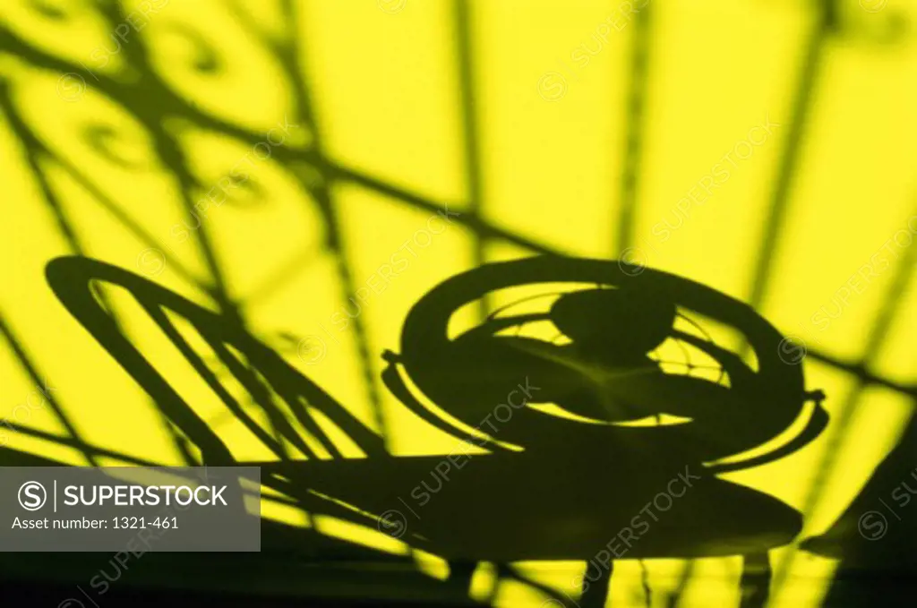 Silhouette of an electric fan on a chair