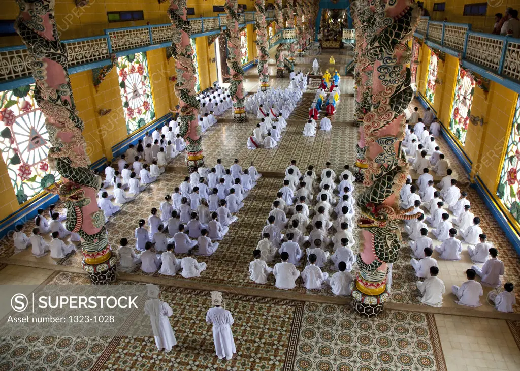 Cao Dai worshippers praying in a temple, Cao Dai Monastery, Tay Ninh, Vietnam