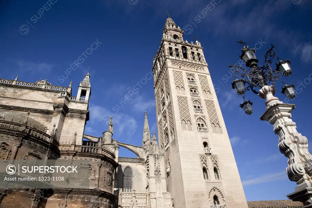Low angle view of bell tower of a church, La Giralda, Seville Cathedral, Seville, Andalusia, Spain