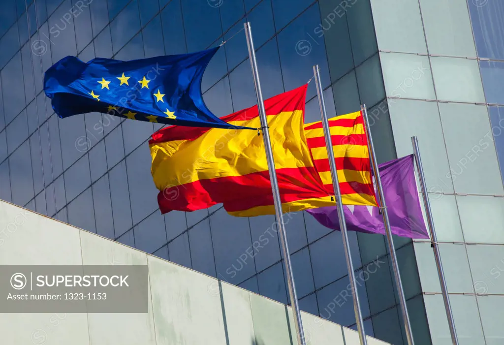 Spain, Barcelona, Flags in front of modern hotel