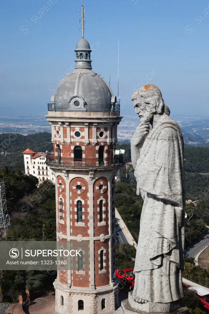Spain, Barcelona, Tibidabo, Statue of sait and tower at Temple Expiatori del Sagrat Cor - The Church of the Sacred Heart