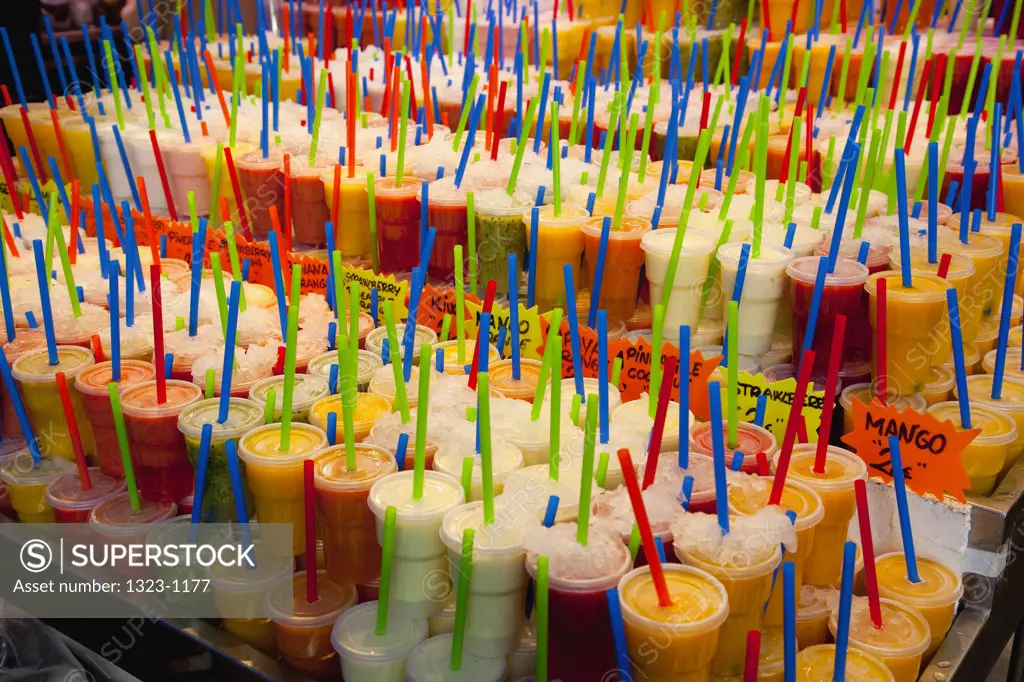 Spain, Barcelona, colorful fruit juices with straws