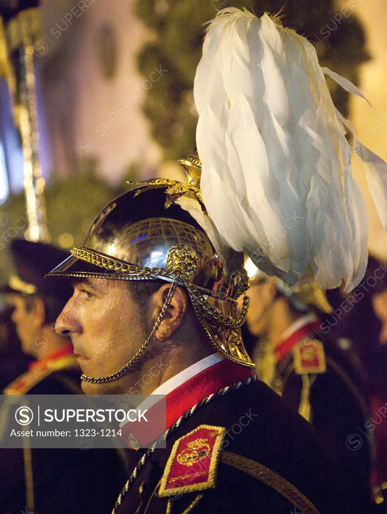 Spain, Seville, Side view of helmet member of marching band during Holy Week celebrations