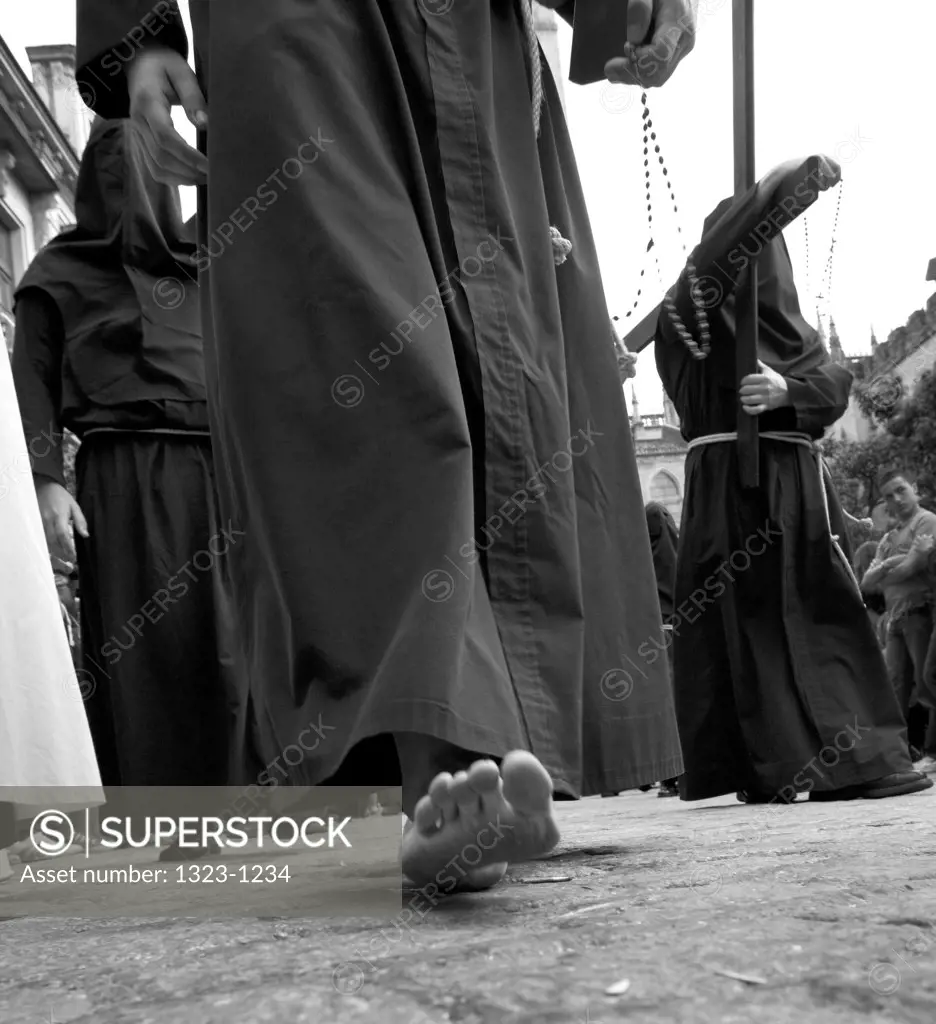 Spain, Seville, Low angle view of penitente with bare feet