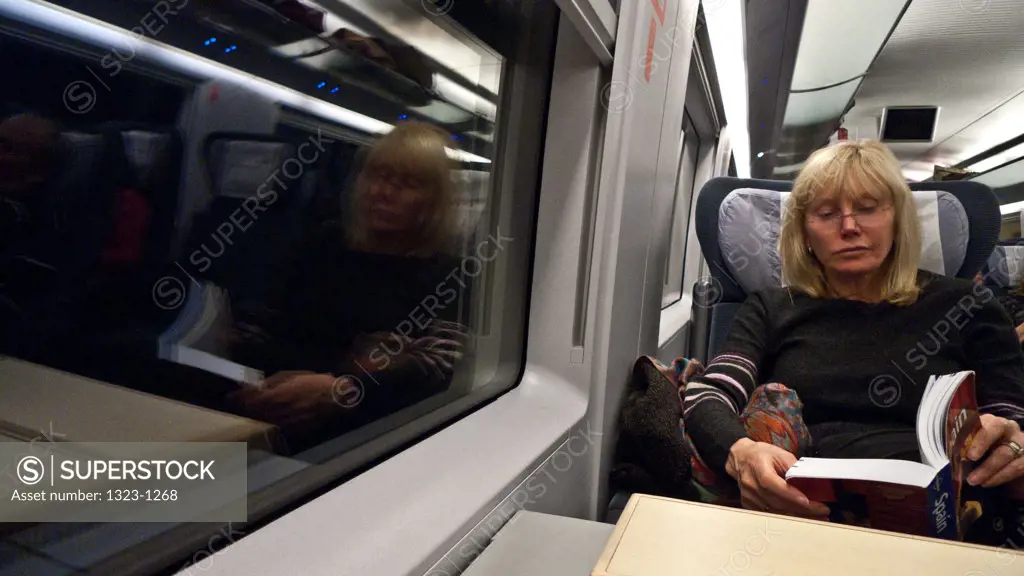 Passenger reading a book in a train