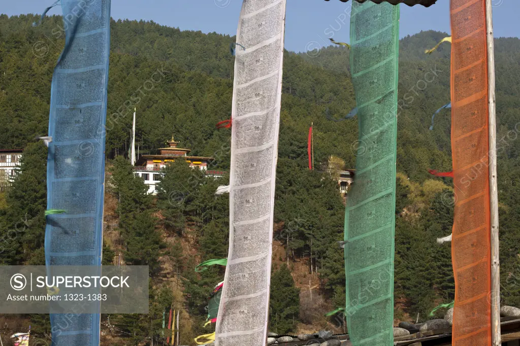 Prayer flags with a monastery in the background, Jakar Dzong, Bumthang, Bhutan