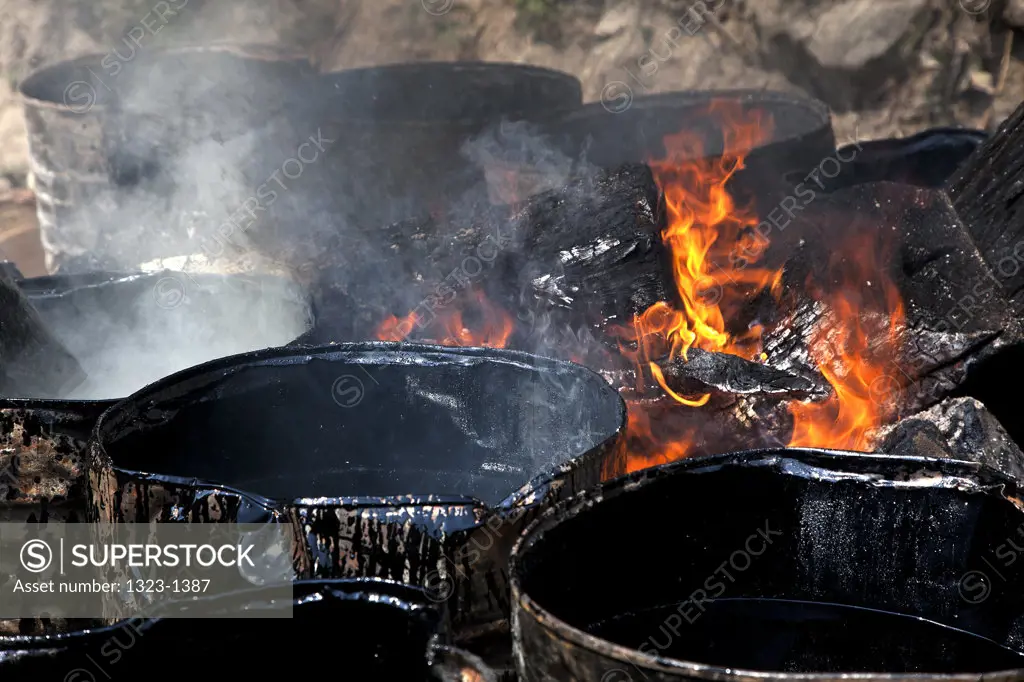 Barrels of tar near the fire, Bhutan