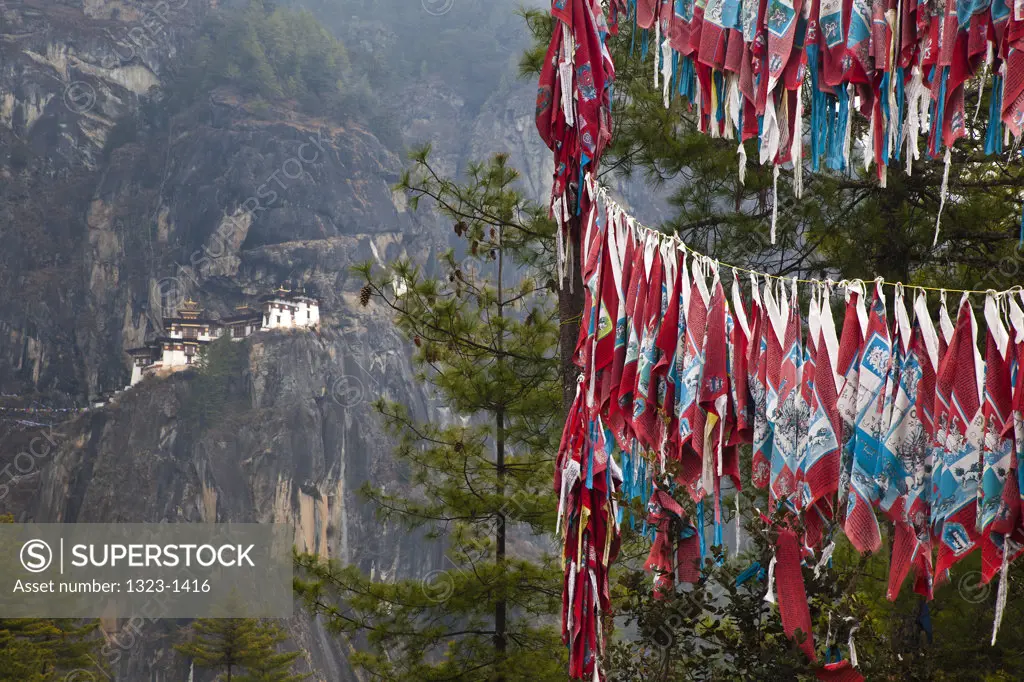 Prayer flags with monastery in the background, Taktsang Monastery, Paro Valley, Paro District, Bhutan