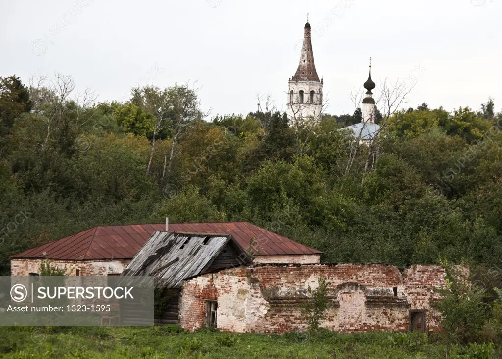 Abandoned house with kremlin in the background, Suzdal, Russia