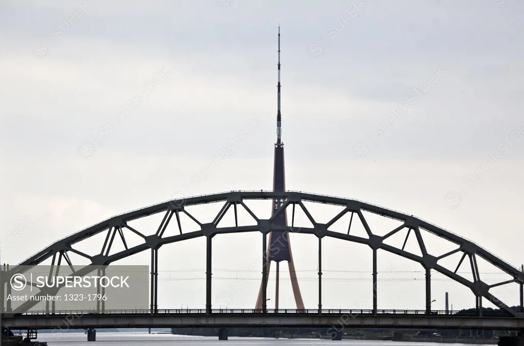 Latvia, Riga, Train bridge over Daugava River, with TV tower in distance