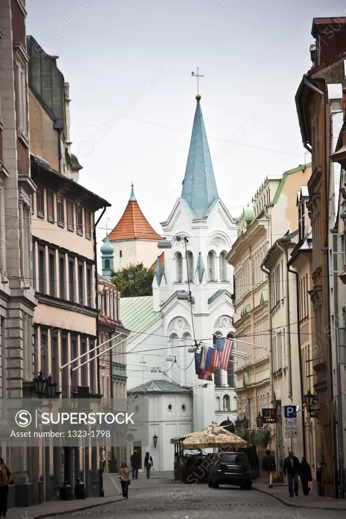 Latvia, Riga, View of street in Old Riga with Grand Palace Hotel and Church