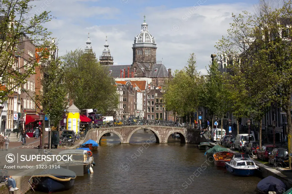 Boats in the canal with the Church of St. Nicholas in the background, Amsterdam, Netherlands