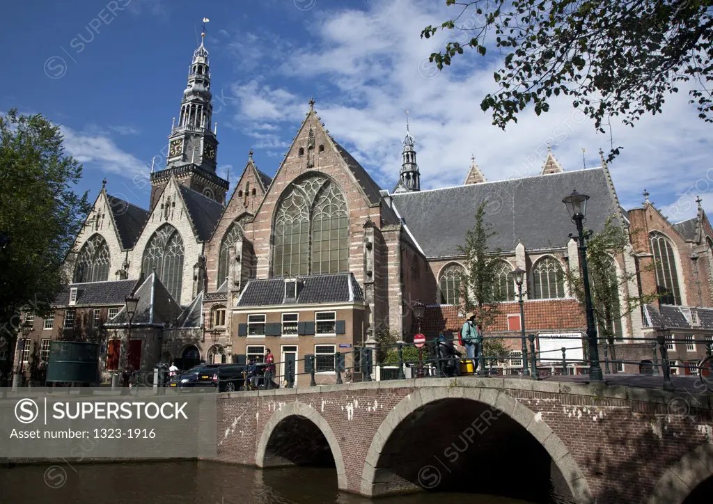 Bridge across canal in front of a church, Oude Kerk Church, Amsterdam, Netherlands