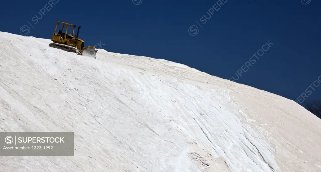USA, Massachusetts, Boston, View of bulldozer on top of mound of salt