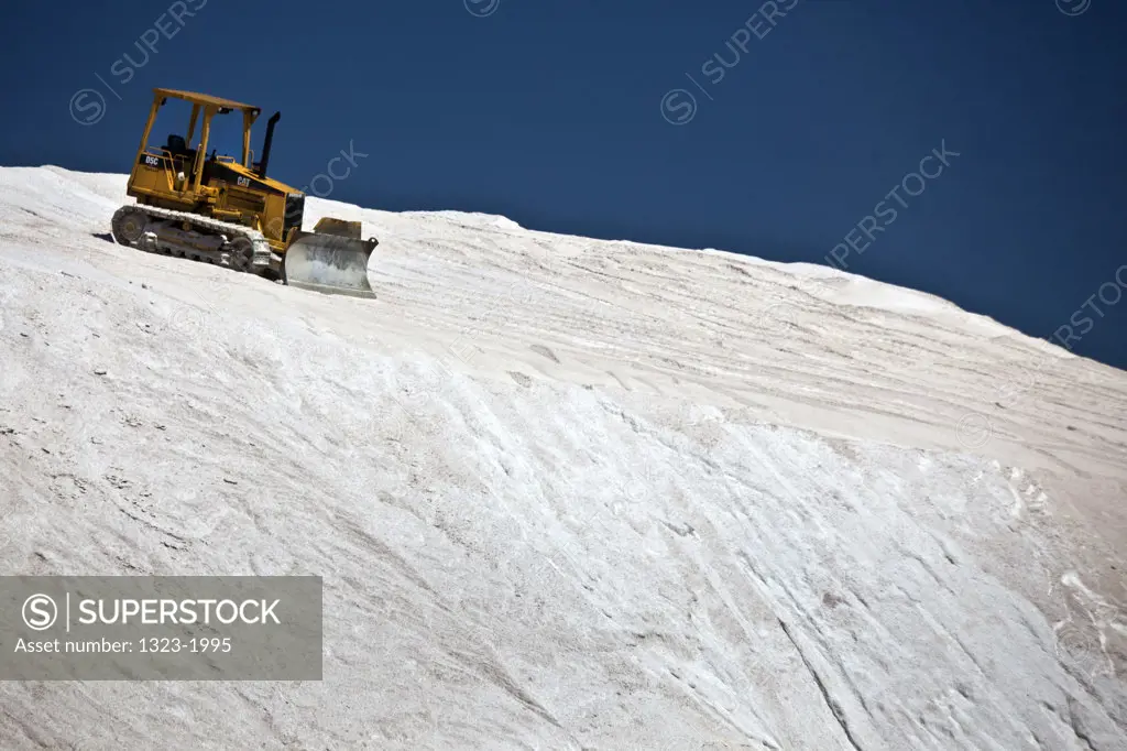 USA, Massachusetts, Boston, View of bulldozer on top of mound of salt