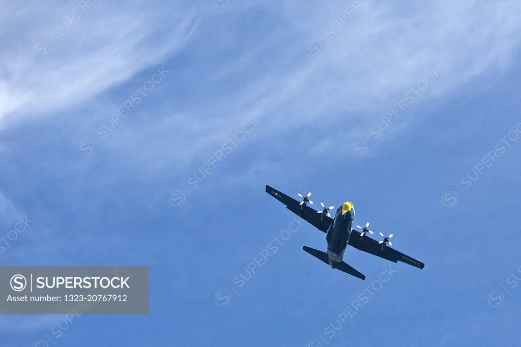 Blue Angels propeller plane flying over San Francisco Bay