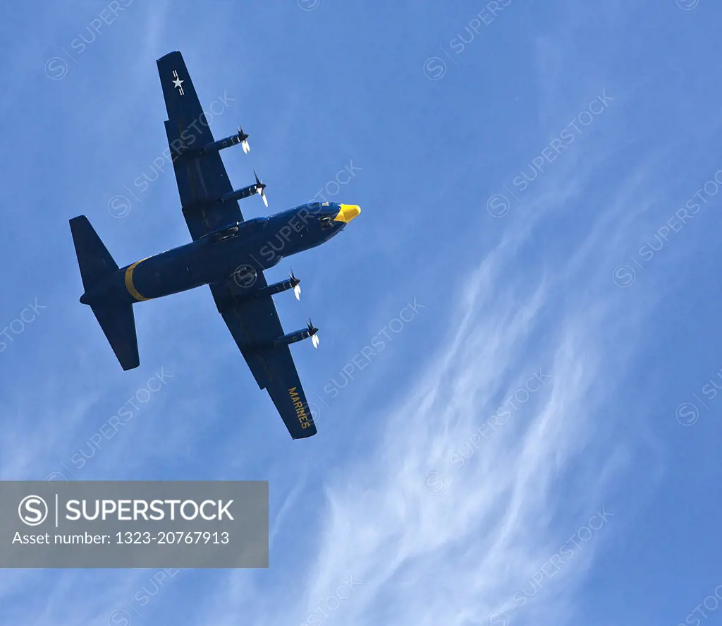 Blue Angels propeller plane flying over San Francisco Bay