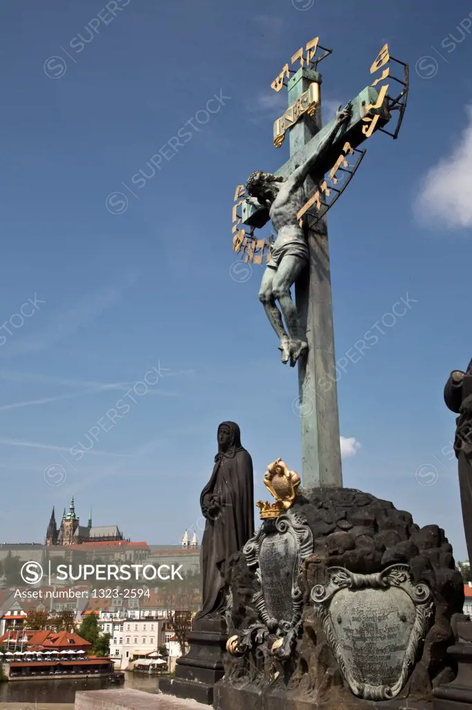 Czech Republic, Praque, Crucifixion statue on Charles Bridge with Praque Castle