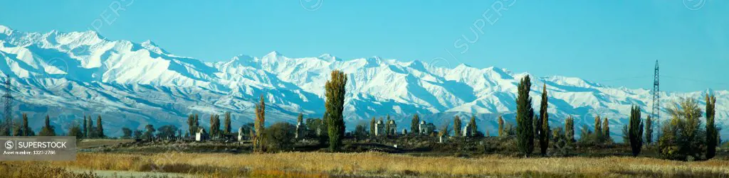 Kyrgyzstan, Moslem cemetery with Tian Shan Mountains